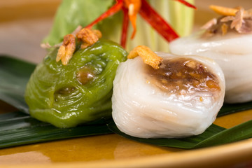 Close up of Streamed Fresh rice flour rolls with mined wood ear fungur, shallots and ground pork on white background; Healthy food concept
