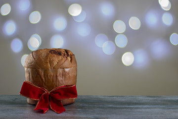 Christmas chocolate cake panettone with a red ribbon in a light background or panetone chocotone