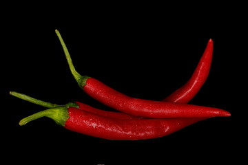 heap of red chili pepper isolated on black background