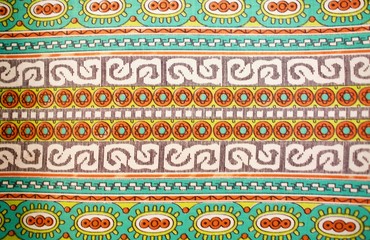 Fragment of colorful retro tapestry text. Fabric striped, flowered texture.