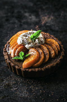 Chocolate ganache apricot tarts with almond oat pastry