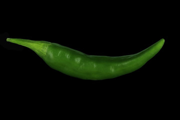 green hot chili pepper isolated on black background