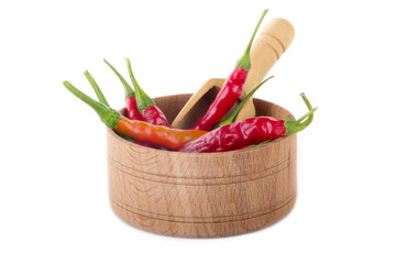 heap of red chili pepper in wooden cup isolated on white background