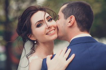 Naklejka premium Sensual portrait of a young couple. Wedding photo outdoor