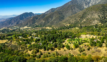 Fototapeta na wymiar Aerial, drone view of Oak Glen located between the San Bernardino Mountains and Little San Bernardino Mountains with several apple orchards before the Fall color change