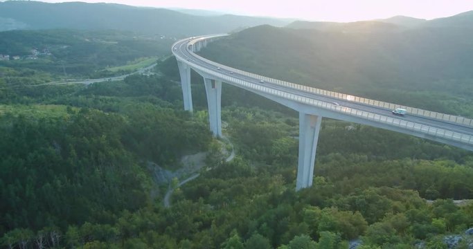4k aerial footage of traffic over viaduct at sunset