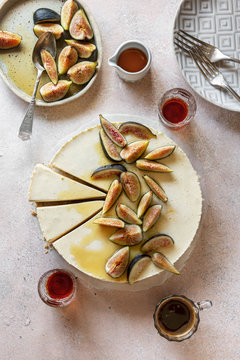 Overhead view of ricotta cheesecake topped with figs on table