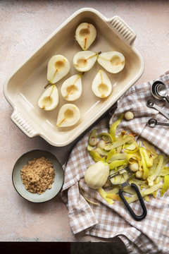 Overhead view of peeled pears in casserole on table