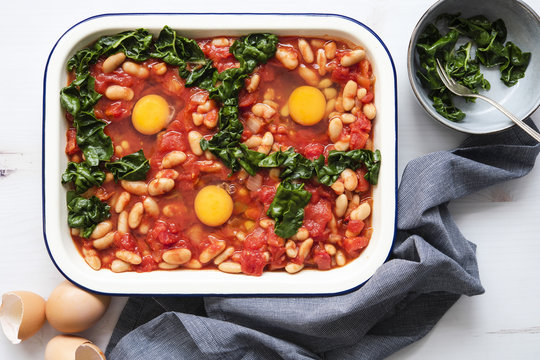 Shakshuka in a baking dish with silverbeet.