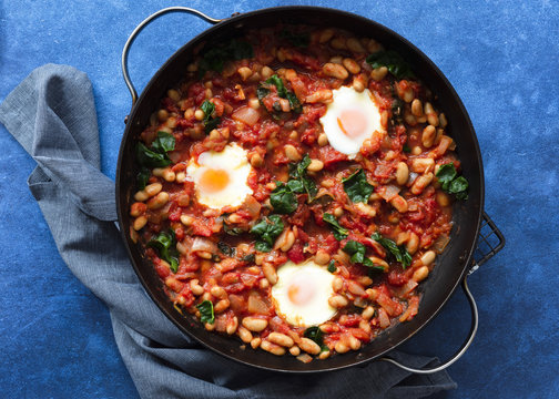 Shakshuka with silverbeet in a pan.