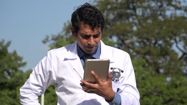 Stressed Hispanic Doctor Using Tablet