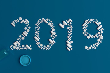 Background of a variety of tablets scattered on a blue background in the form of a silhouette text 2019 3d illustration