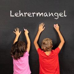girl and boy writing on a blackboard, german text lehrermangel, in english teachers lack - 228361324