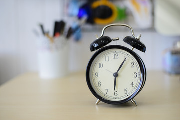 Black alarm clock on the table