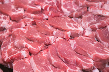 Fresh raw pork chops at butcher shop