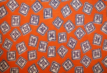 Fragment of colorful retro tapestry text. Fabric striped, flowered texture.