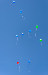 air multicolored balls in the blue sky. Helium balls - red, blue, white, colorful balls flying against the blue