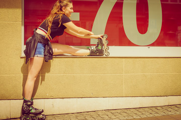 Woman wearing roller skates next to sale