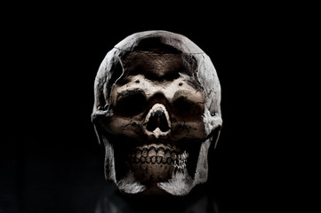 Obraz premium Ceramic skulls on black background. Halloween decor.