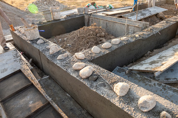 Workers lay the foundation for a new home