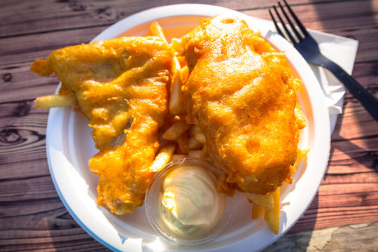 Fried battered fish with chips on a plate