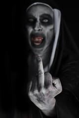 frightening evil nun giving the finger