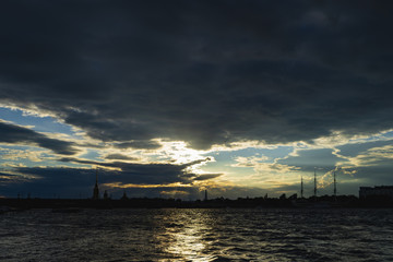 The contours of the buildings of St. Petersburg against the evening sky. View from the Neva.