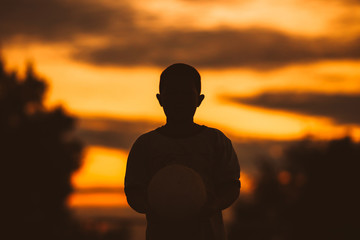 Fototapeta premium kids are playing soccer football for exercise under the sunlight. Silhouette and film picture style.