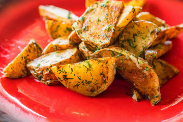Baked potato wedges with dill and spices close