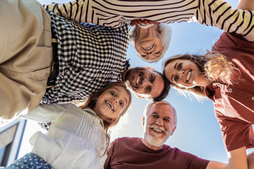 Gather at time. Delighted brunette bearded man keeping smile on his face while looking downwards