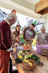 Make a wish. Pleased little girl feeling happiness while having birthday