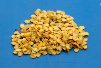 bitter pepper seeds on a blue background macro
