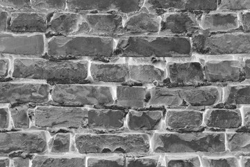 Warm grey brick wall texture background. Tiled.
