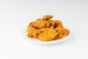Fried breaded chicken fillet isolated on white background with selective focus and crop fragment