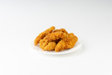 Fried breaded chicken fillet isolated on white background with selective focus and crop fragment