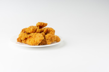 Fried breaded chicken fillet isolated on white background with selective focus and crop fragment