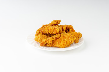 Fried breaded chicken fillet isolated on white background with selective focus and crop fragment