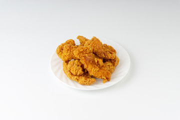 Fried breaded chicken fillet isolated on white background with selective focus and crop fragment