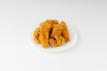 Fried breaded chicken fillet isolated on white background with selective focus and crop fragment