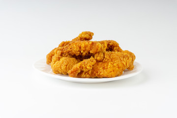 Fried breaded chicken fillet isolated on white background with selective focus and crop fragment