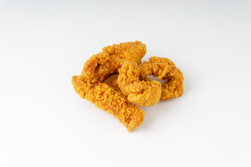 Fried breaded chicken fillet isolated on white background with selective focus and crop fragment