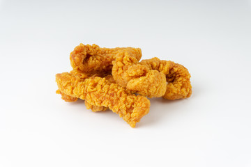 Fried breaded chicken fillet isolated on white background with selective focus and crop fragment