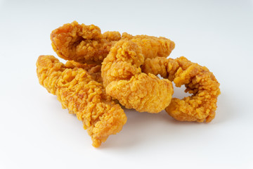 Fried breaded chicken fillet isolated on white background with selective focus and crop fragment