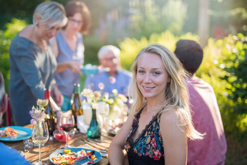 Family picnic. Focus to a beautiful young woman looks at camera