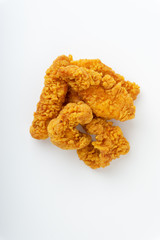 Fried breaded chicken fillet isolated on white background with selective focus and crop fragment