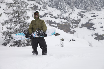 Fototapeta na wymiar Snowboarder with snowboard clothes in the snow powder