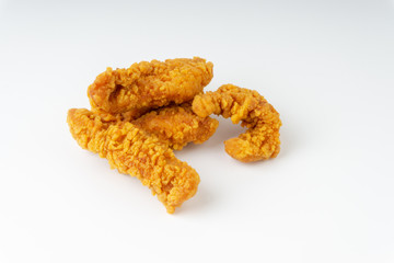 Fried breaded chicken fillet isolated on white background with selective focus and crop fragment