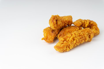 Fried breaded chicken fillet isolated on white background with selective focus and crop fragment