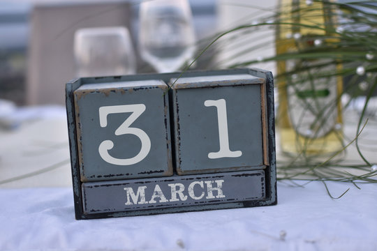 Wood blocks in box with date, day and month 31 March. Wooden blocks calendar