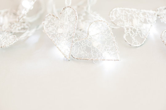 White background with a burning Christmas garland. Copy space.